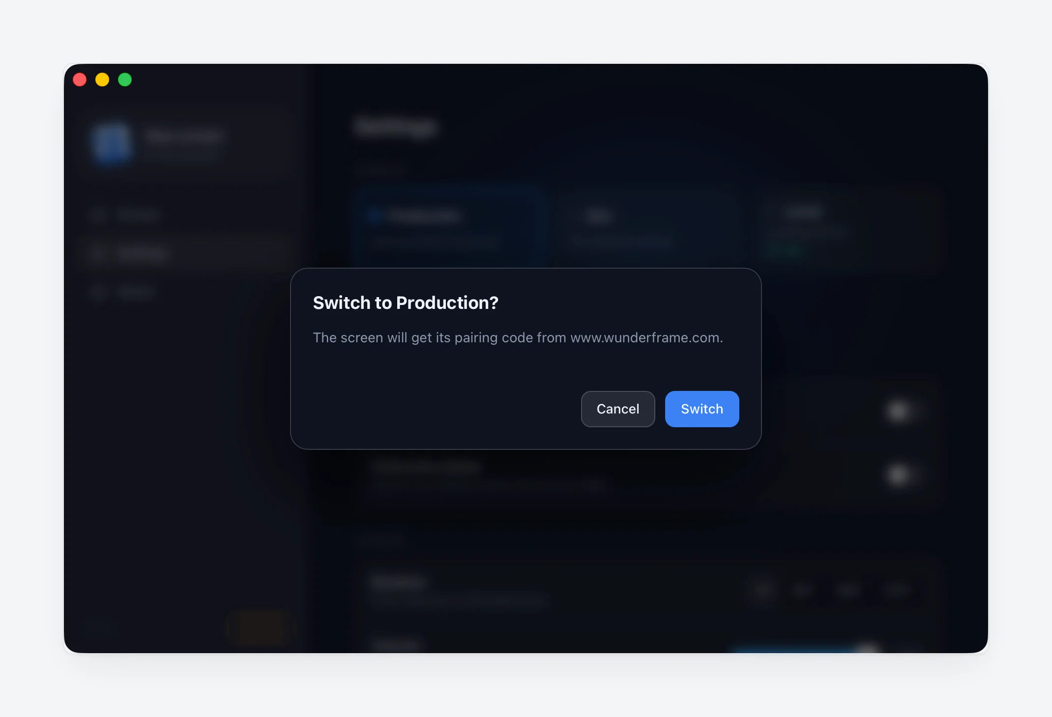 A confirmation dialog over the desktop player: 'Switch to Production? The screen will get its pairing code from www.wunderframe.com.' with Cancel and Switch buttons.